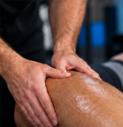 Hands applying sports massage treatment to the leg